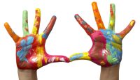 close up of child  hands painted with watercolors, on white background with clipping path